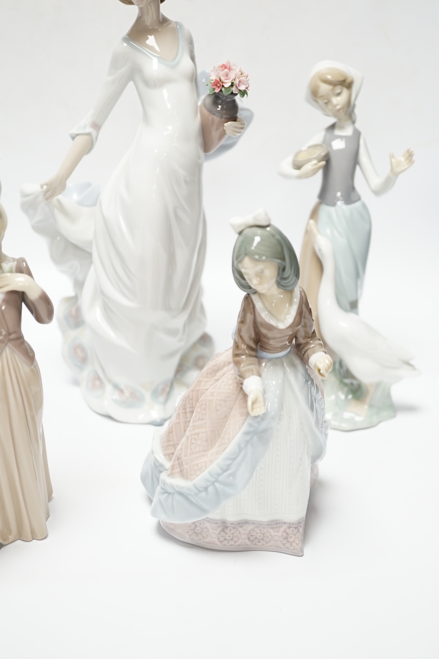 Four Lladro figurines; Reverie Moment, a model of a Ballet Dancer, and three other figurines (only two boxed)